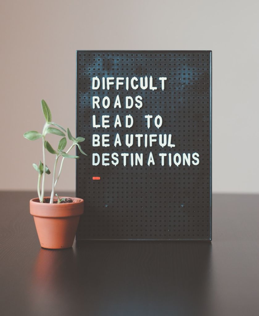 Photo by Nik difficult roads lead to beautiful destinations desk decor